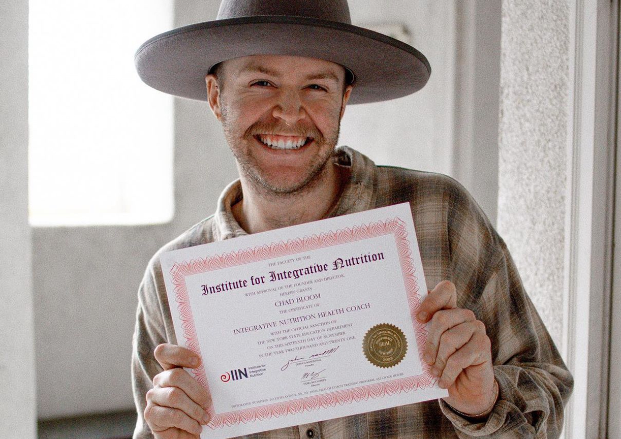Smiling man with health coaching certificate